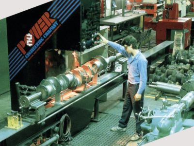 Crankshaft straightening press showing crankshaft and machine operator
