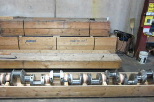 Waukesha crankshaft, 16V_AT-25, within crate inside of warehouse