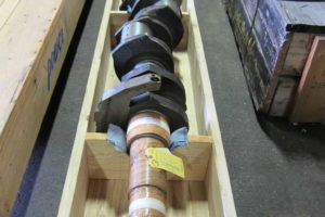 Waukesha crankshaft, P9390 within crate inside of warehouse